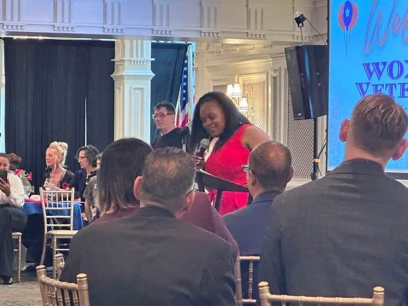 Guests seated at tables during the program