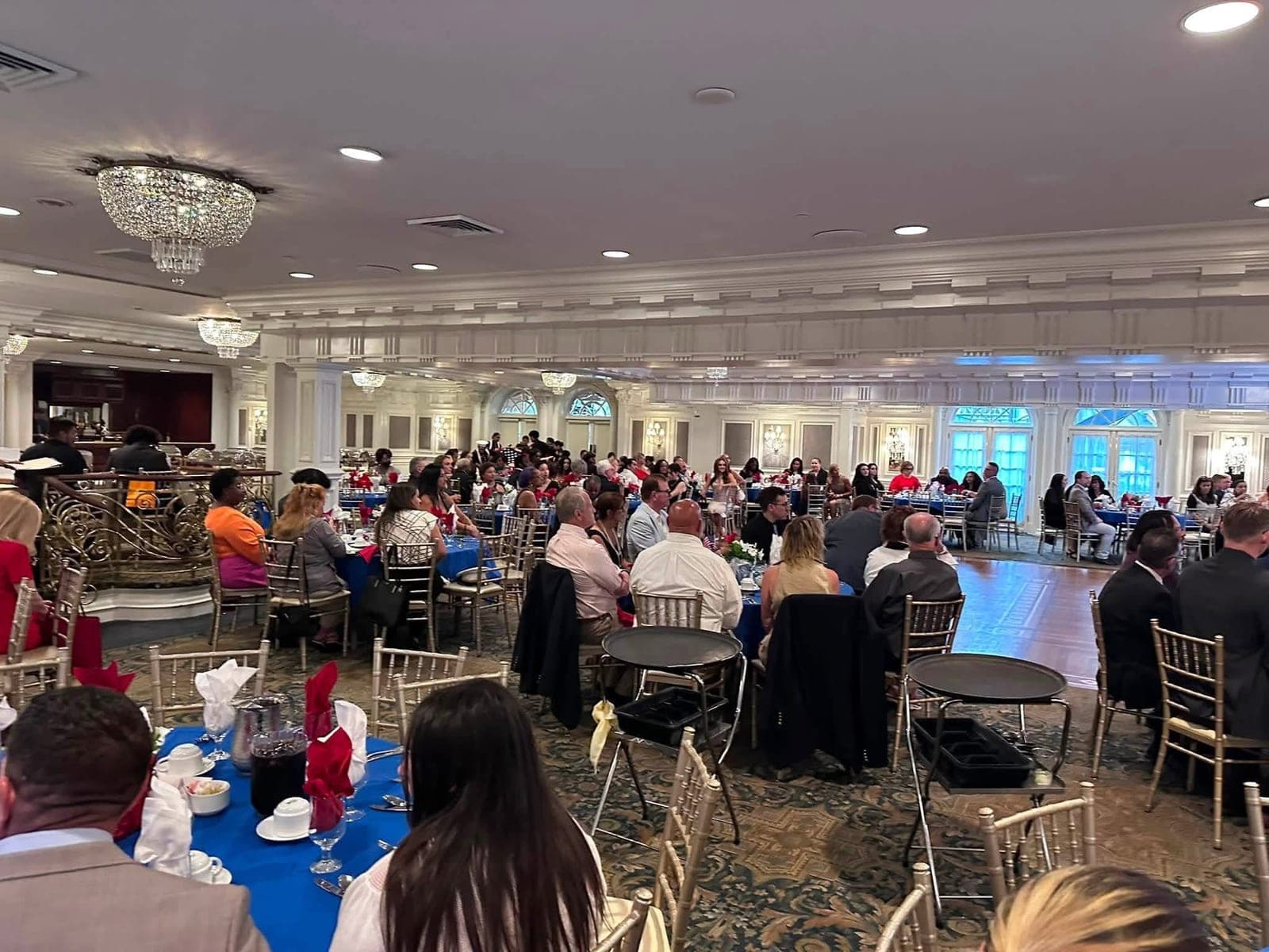 Attendees seated at tables in the ballroom