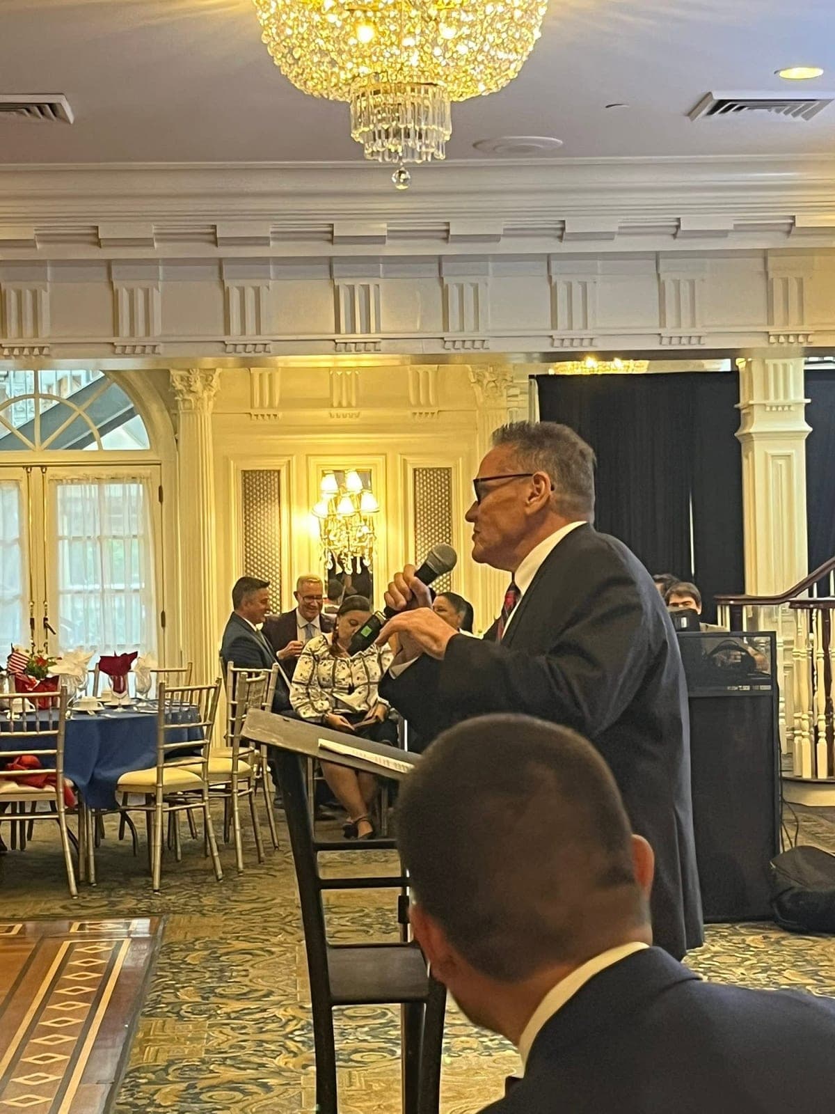 A speaker addressing seated guests