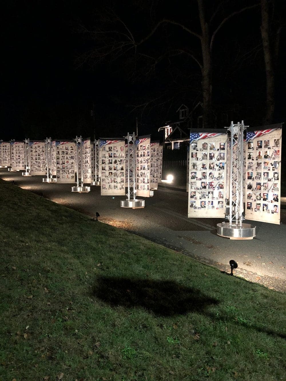 Remembering Our Fallen memorial banners lit at night